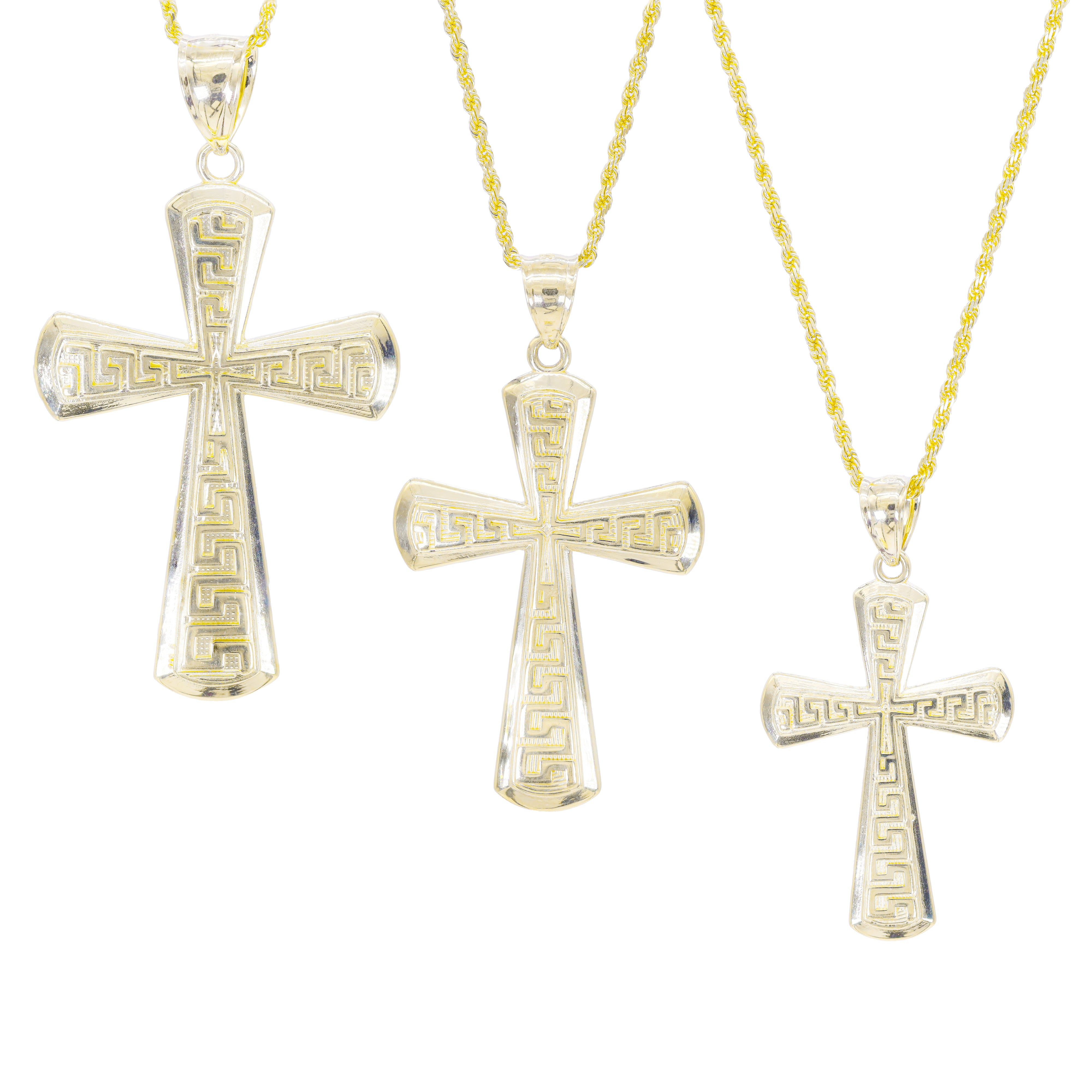 Three gold different sizes of cross pendants on gold chains with a Greek key design on top